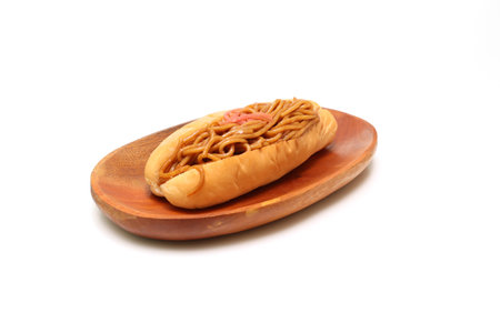 Fried noodle sandwich on a wooden plate isolated on a white background.の写真素材