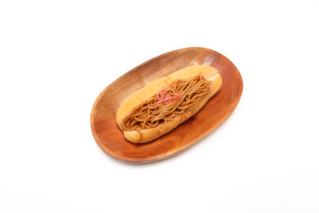 Fried noodle sandwich on a wooden plate isolated on a white background.の写真素材