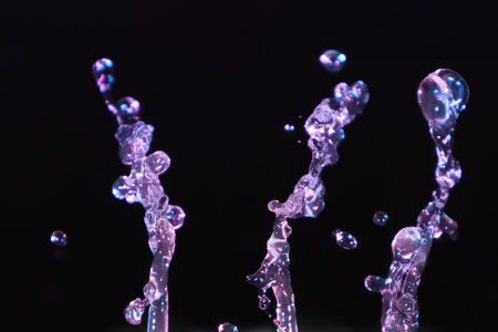 Water splashes isolated on black background. Water drops in motion.の写真素材