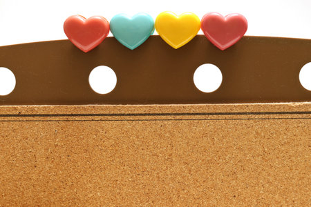 colorful hearts on a cork board isolated on a white backgroundの写真素材