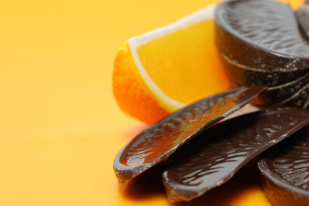 Orange flavor chocolates isolated on a orange background.の写真素材