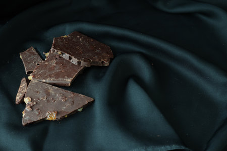 Orange flavor chocolates on a black background.