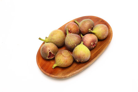Figs isolated on a wooden plat on a white background.の写真素材