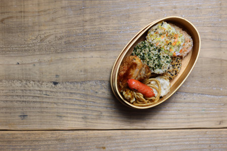 Japanese food in a box on a wooden background. Top view.の写真素材