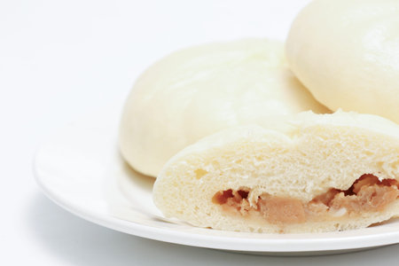 Pork buns on a plate isolated on a white background.