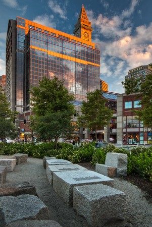 A view from the Boston Greenway of the Custom's House lit up with the setting sunの写真素材