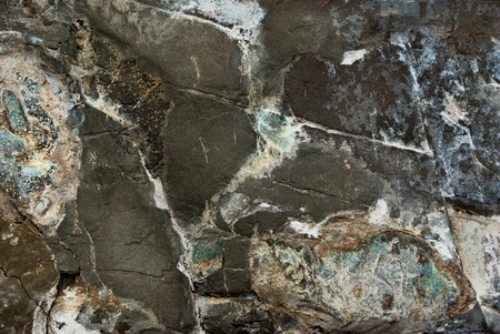A stone wall make with old granite blocks is shown in closeupの写真素材
