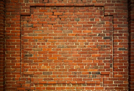Old brick wall with decorative bricks forming an internal frameの写真素材