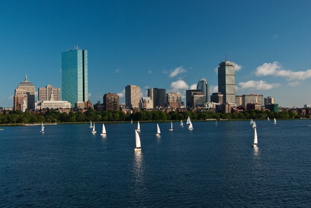 A view of Boston Massachusetts across the Charles River with sailboats in the foreground during a late summer afternoonのeditorial素材