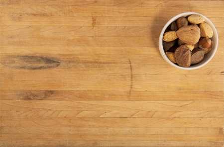 A bowl of mixed nuts sit on a worn countertopの写真素材