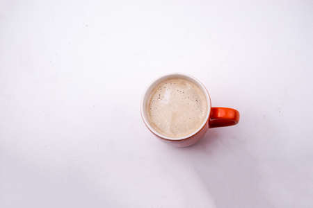 Orange mug with coffee isolated on a white background. Top viewの写真素材
