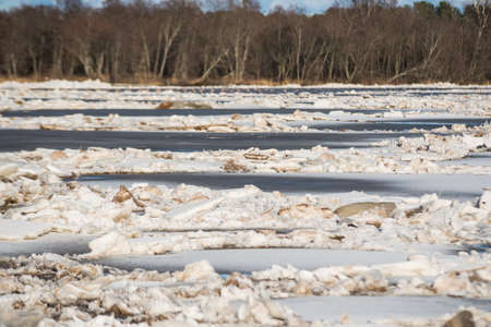 Spring floods. Sedimentation of ice blocks in a river that forms an ice block.