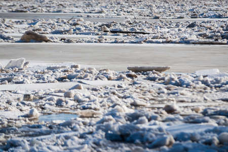Spring floods. Sedimentation of ice blocks in a river that forms an ice block.