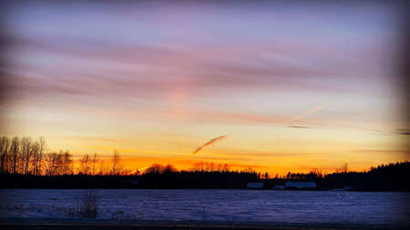 Beautiful orange sunset on a winter evening in a rural area. Panoramas in the pictureの写真素材