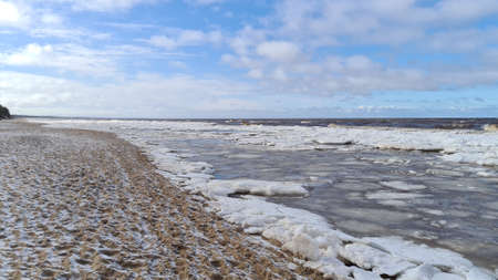 Baltic Sea on wintertime with broken ice cracks. Large pieces of floating ice driven into the seaside. Pack Ice builds up the icebergs. Panoramaの写真素材