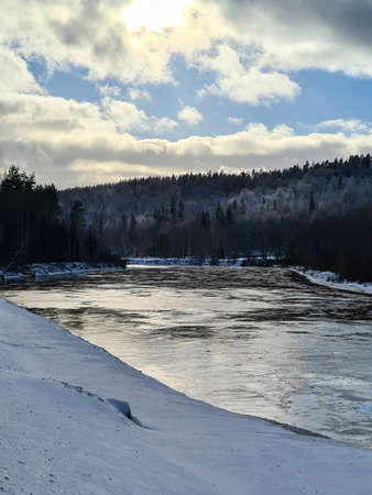 Winter sunset rural river landscape. Sunset winter rural river view. Winter village river sunset...