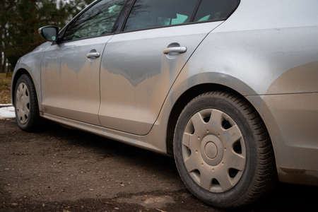 The dirty side of the car. The machine. Design element. Grey car in spring timeの写真素材