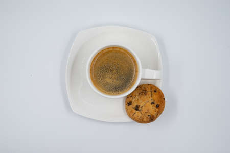 Top view. White coffee mug with biscuit and coffee on a white backgroundの写真素材
