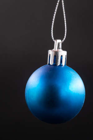 blue christmas ball isolated on black backgroundの写真素材