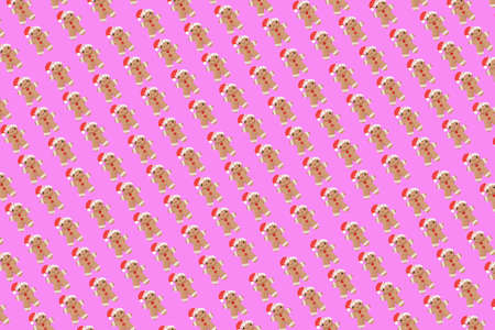 New Year concept. Trendy pattern made with Christmas gingerbread man on bright light pink...