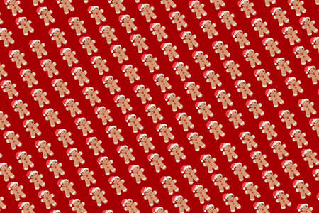 New Year concept. Trendy pattern made with Christmas gingerbread man on bright light red background....