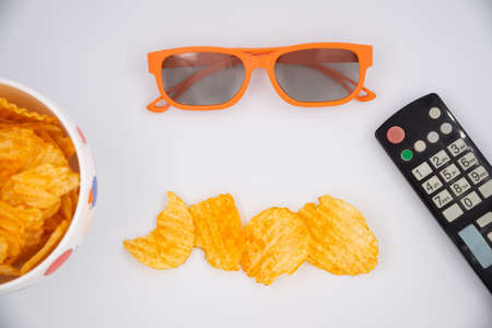 Potato chips for cinema. Watching movies with TV control, 3D glasses and snacks.