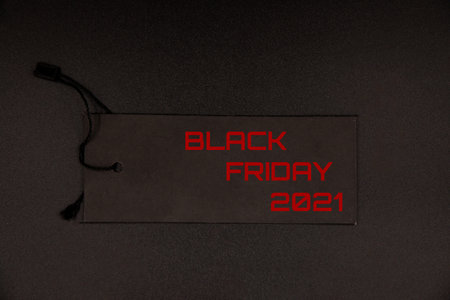 Black Friday 2021 text on a black tag on black backgroundの写真素材
