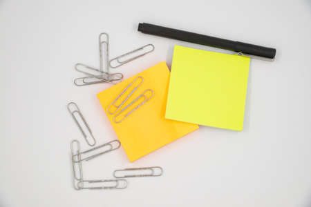 Selective focus of colorful sticky notes and paper clips. Flat lay, top view. Copy space.の写真素材