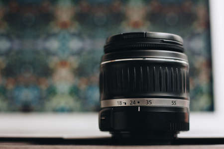 Close-up of a photo lens with a bokeh background on the table.の写真素材