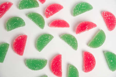 Sweet pattern, marmalade jelly candies of different colors on a white background with sugar...