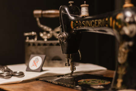 Riga, Latvia - March 30: Singer sewing machine and his table. Issac Singer built the first sewing...