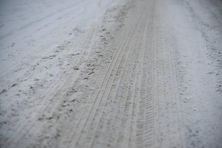 Wheel tracks on the winter road covered with snow.の写真素材