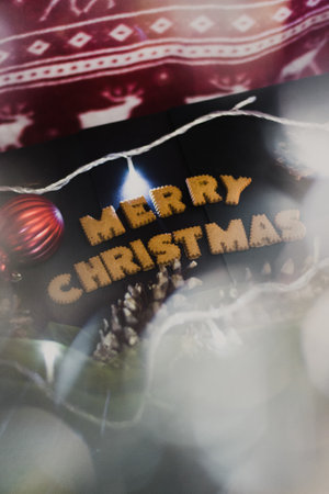 Gingerbread words Merry Christmas on old black table with Christmas decorationsの写真素材