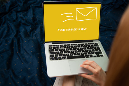 Woman using a laptop with email concept on the screen. All screen content is designed by meの写真素材