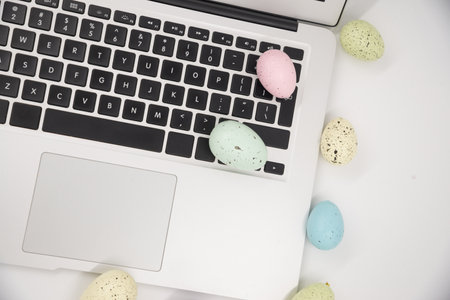 Computer with blank empty screen on white background of easter eggs. Space for text. Happy Easter!の写真素材