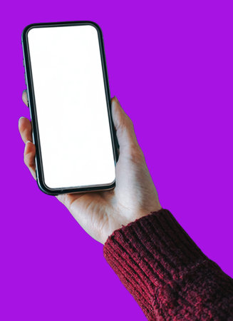 A hand holding a modern smartphone with a blank white screen against a vibrant purple background. The device is shown vertically, ideal for app presentation, mobile interface mockuの写真素材