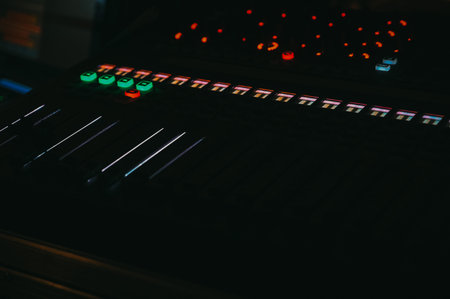 Riga, Latvia - February 28, 2026:Close-up of a professional audio mixing console with illuminated...