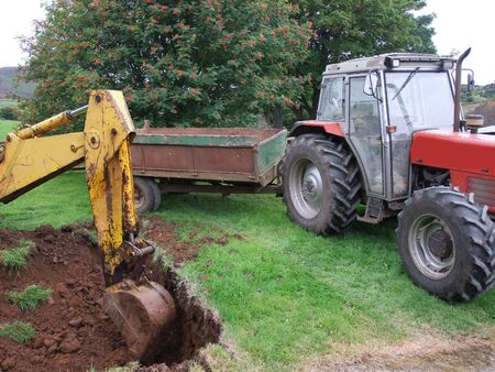 Yellow Digger digging out foundations for an extinction to a bungalow