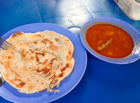 Indian traditional roti prata cuisine with curry side dishの写真素材