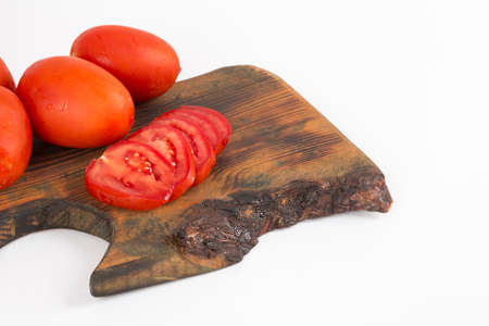 organic red tomatoes on wooden background on white backgroundの写真素材