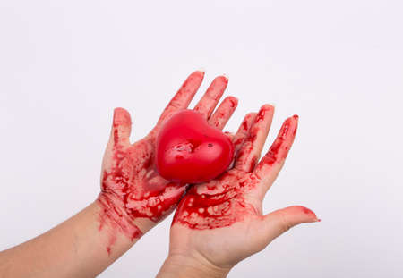 blood-stained heart and hand white backgroundの写真素材