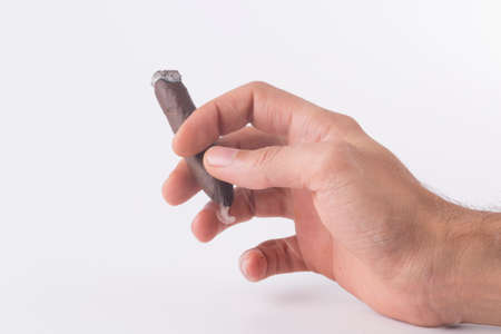 cigar and hand white background isolated photoの写真素材