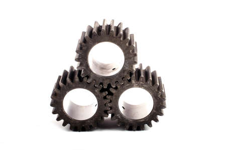 Small group of gears with their teeth engaged on a white background