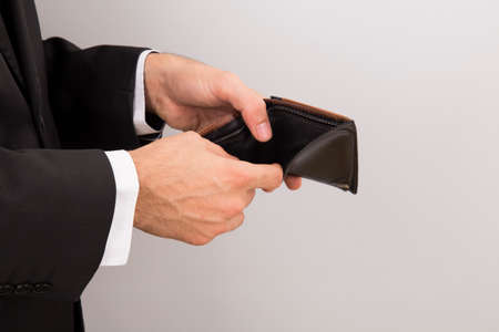 businessman holding empty wallet , gray background ,の写真素材