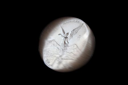 rotating coin of pure silver from mexico named onza libertadの写真素材