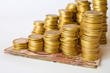piles of golden coins on bills, mexican pesos moneyの写真素材