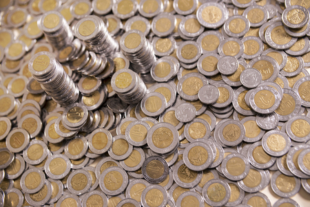 a lot of mexican pesos coins backgroundの写真素材