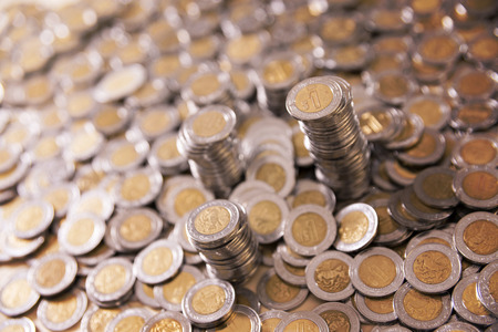 a lot of mexican pesos coins backgroundの写真素材