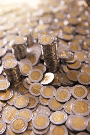 a lot of mexican pesos coins backgroundの写真素材