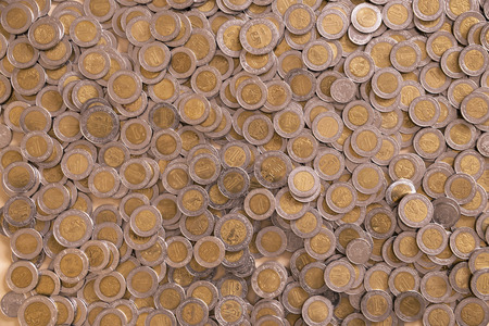 a lot of mexican pesos coins backgroundの写真素材